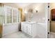 Bathroom featuring a single sink vanity, wainscoting, and stylish mirror at 3018 Bradshaw Club Dr, Woodstock, GA 30188