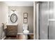 Bathroom featuring a wood vanity, toilet, and frameless glass shower door at 3018 Bradshaw Club Dr, Woodstock, GA 30188