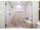 Modern bathroom with glass shower, tile surround, pebble floor, and built in bench at 3018 Bradshaw Club Dr, Woodstock, GA 30188
