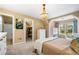 Bedroom with an ensuite bathroom, a large window, and closet access at 3018 Bradshaw Club Dr, Woodstock, GA 30188