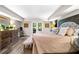 Cozy bedroom with neutral walls, wood floors, and french doors to backyard at 3018 Bradshaw Club Dr, Woodstock, GA 30188
