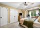 Cozy bedroom with carpet features a ceiling fan, windows, and closet with doors at 3018 Bradshaw Club Dr, Woodstock, GA 30188