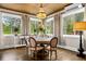 Bright breakfast nook with a chandelier and a view of the trees outside at 3018 Bradshaw Club Dr, Woodstock, GA 30188