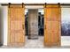 Primary closet with custom storage featuring rustic sliding barn doors for easy access at 3018 Bradshaw Club Dr, Woodstock, GA 30188
