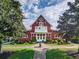Charming red clubhouse featuring landscaped grounds and a welcoming entrance at 3018 Bradshaw Club Dr, Woodstock, GA 30188
