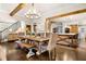 Open dining area with wooden table, chandelier, and natural light flowing from the kitchen at 3018 Bradshaw Club Dr, Woodstock, GA 30188