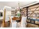 Charming dining room with a round wood table, upholstered chairs, and decorative shelving at 3018 Bradshaw Club Dr, Woodstock, GA 30188