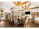 Spacious dining area with wood beam ceilings connecting to living room and abundant natural light at 3018 Bradshaw Club Dr, Woodstock, GA 30188