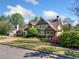 Charming two-story home with landscaped yard, circular driveway, and classic architectural details at 3018 Bradshaw Club Dr, Woodstock, GA 30188