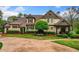 Charming two-story home with landscaped yard, circular driveway, and classic architectural details at 3018 Bradshaw Club Dr, Woodstock, GA 30188