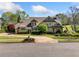Charming two-story home with landscaped yard, circular driveway, and classic architectural details at 3018 Bradshaw Club Dr, Woodstock, GA 30188