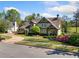 Charming two-story home with landscaped yard, circular driveway, and classic architectural details at 3018 Bradshaw Club Dr, Woodstock, GA 30188
