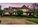 Charming two-story home with landscaped yard, circular driveway, and classic architectural details at 3018 Bradshaw Club Dr, Woodstock, GA 30188