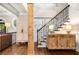 Bright foyer with hardwood floors, staircase with iron spindles and custom sideboard at 3018 Bradshaw Club Dr, Woodstock, GA 30188