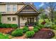 Inviting front porch with manicured landscaping and charming entry details at 3018 Bradshaw Club Dr, Woodstock, GA 30188