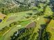 Scenic aerial view of a lush golf course with ponds and sand traps at 3018 Bradshaw Club Dr, Woodstock, GA 30188