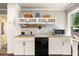 Kitchen with white cabinetry, tile backsplash, black appliances, and wood-look flooring at 3018 Bradshaw Club Dr, Woodstock, GA 30188