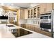 Bright kitchen featuring light wood cabinets, stainless steel appliances, and a large island with cooktop at 3018 Bradshaw Club Dr, Woodstock, GA 30188