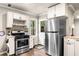 Bright kitchen with stainless steel appliances, door to outside, and tile countertops at 3018 Bradshaw Club Dr, Woodstock, GA 30188