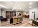 Spacious living room with built-in bookshelves, dining table, and wood-look flooring at 3018 Bradshaw Club Dr, Woodstock, GA 30188