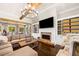 Open-concept living room with fireplace, built-in shelving, and abundant natural light at 3018 Bradshaw Club Dr, Woodstock, GA 30188