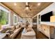Spacious living room featuring wood ceilings, many windows, and comfortable seating at 3018 Bradshaw Club Dr, Woodstock, GA 30188