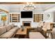 Inviting living room with a brick fireplace, wood beams, and custom built-in shelving at 3018 Bradshaw Club Dr, Woodstock, GA 30188
