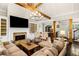 Charming living room features a brick fireplace, wood beams, and a cozy seating area at 3018 Bradshaw Club Dr, Woodstock, GA 30188