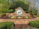 Entrance to the 'Bradshaw Farm' community, showcasing landscaping and brick aesthetics at 3018 Bradshaw Club Dr, Woodstock, GA 30188