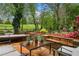 Backyard patio with outdoor seating and lush landscaping at 3018 Bradshaw Club Dr, Woodstock, GA 30188