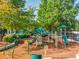 A vibrant playground with slides and climbing structures for , nestled in a wooded community area at 3018 Bradshaw Club Dr, Woodstock, GA 30188