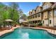 Backyard pool with outdoor seating and manicured landscaping at 3018 Bradshaw Club Dr, Woodstock, GA 30188