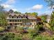 Gorgeous backyard features a large pool, a covered patio, and lush landscaping offering privacy at 3018 Bradshaw Club Dr, Woodstock, GA 30188