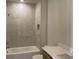 Cozy bathroom featuring a shower-tub, tiled walls, and a vanity with countertop at 3063 Reserve Ct Sw, Conyers, GA 30094