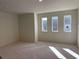 Bright, large bedroom with three large windows and neutral carpeting at 3063 Reserve Ct Sw, Conyers, GA 30094