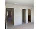 Bedroom featuring three open doorways, showing access to other rooms in the house at 3063 Reserve Ct Sw, Conyers, GA 30094