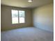 View of a bright and spacious bedroom with a large window offering natural light at 3063 Reserve Ct Sw, Conyers, GA 30094