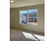 Bright bedroom featuring neutral walls, carpet, and a window with a scenic outdoor view at 3063 Reserve Ct Sw, Conyers, GA 30094