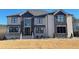A luxury home with brick and stone and black windows complemented by manicured lawn at 3063 Reserve Ct Sw, Conyers, GA 30094
