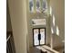 A view of the bright open foyer with tall ceilings, a modern light fixture, and window accents at 3063 Reserve Ct Sw, Conyers, GA 30094