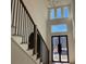 View of the home's light-filled foyer, showcasing tall windows and modern light fixture at 3063 Reserve Ct Sw, Conyers, GA 30094
