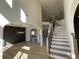 Grand foyer with hardwood floors, staircase with wood and iron banister, and arched doorway at 3063 Reserve Ct Sw, Conyers, GA 30094