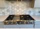 High-end gas range with stylish hexagon backsplash perfect for cooking enthusiasts at 3063 Reserve Ct Sw, Conyers, GA 30094