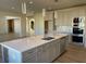 Bright kitchen with modern island, stainless steel appliances, hardwood floors and modern lighting at 3063 Reserve Ct Sw, Conyers, GA 30094