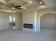 Bright living room with tray ceilings, a ceiling fan, a fireplace, and large archway to another room at 3063 Reserve Ct Sw, Conyers, GA 30094