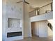 Bright living room with tall ceilings, modern fireplace, and a view of the second floor railing at 3063 Reserve Ct Sw, Conyers, GA 30094