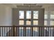 Upper-level view into the light-filled living room with coffered ceilings and large windows at 3063 Reserve Ct Sw, Conyers, GA 30094
