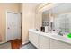 Bright bathroom with double sink vanity, large mirror, modern fixtures, and neutral color scheme at 5147 Winding Glen Dr, Lithonia, GA 30038