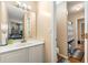 Bright bathroom featuring modern vanity, large mirror, updated fixtures, and a walk-in shower at 5147 Winding Glen Dr, Lithonia, GA 30038