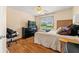 Comfortable bedroom featuring a full-size bed, dresser, TV, and a work chair at 5147 Winding Glen Dr, Lithonia, GA 30038